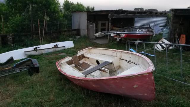 ragged looking boat surrounded by other boat projects